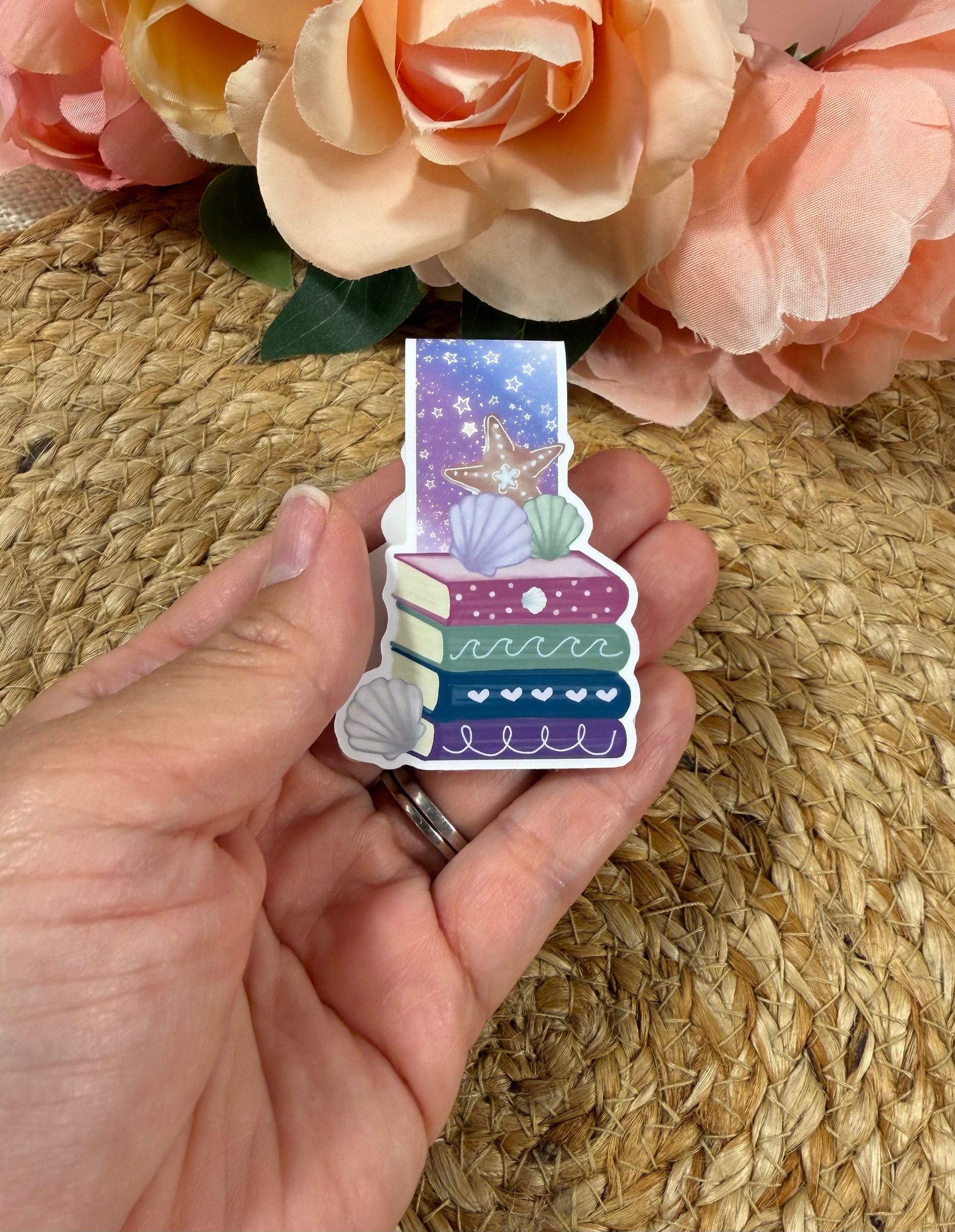 Beach Books magnetic bookmark held in hand to show its size and beach-inspired design.