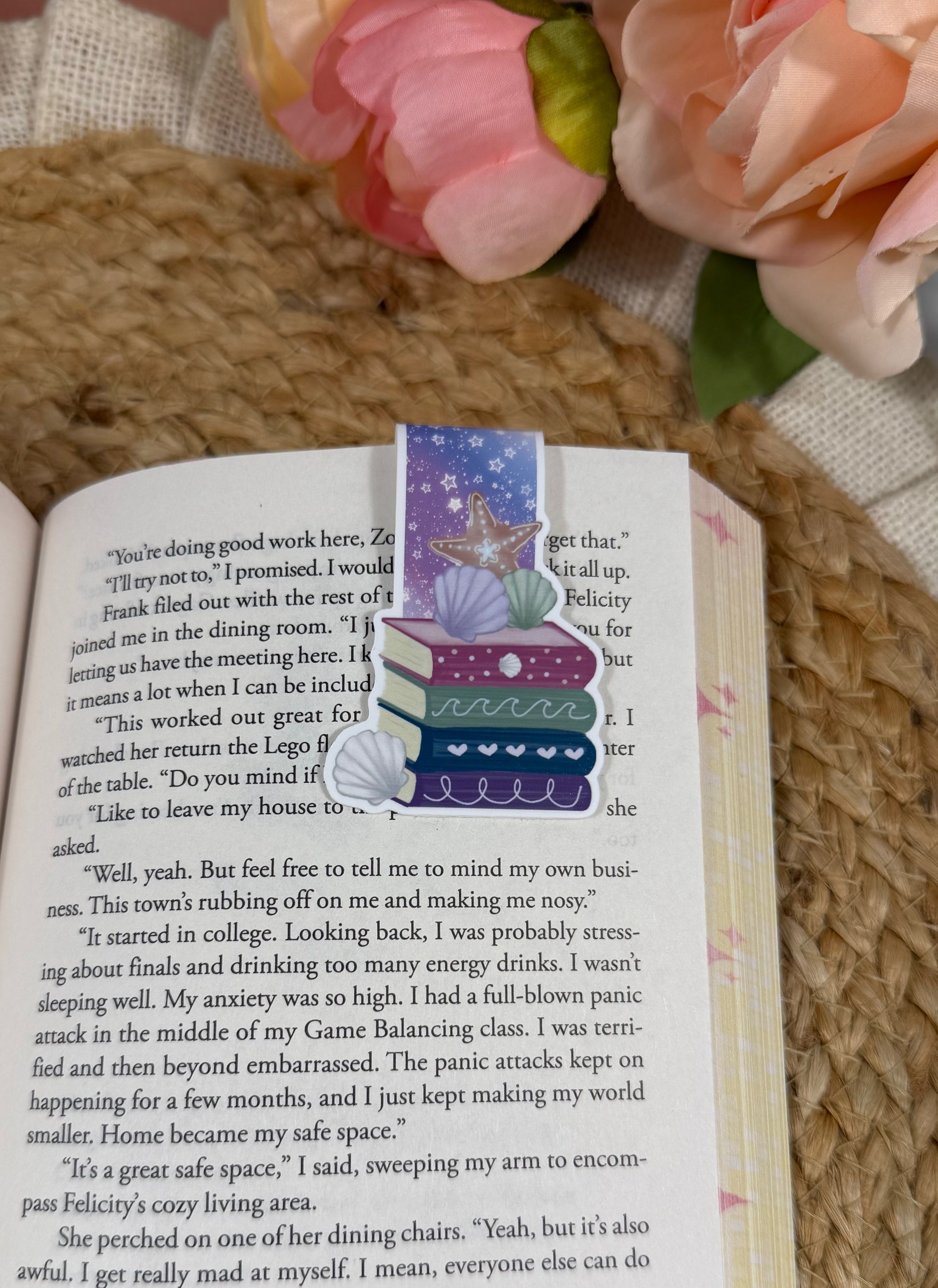 Beach Books magnetic bookmark clipped to a book page, showing how it marks your place while reading.