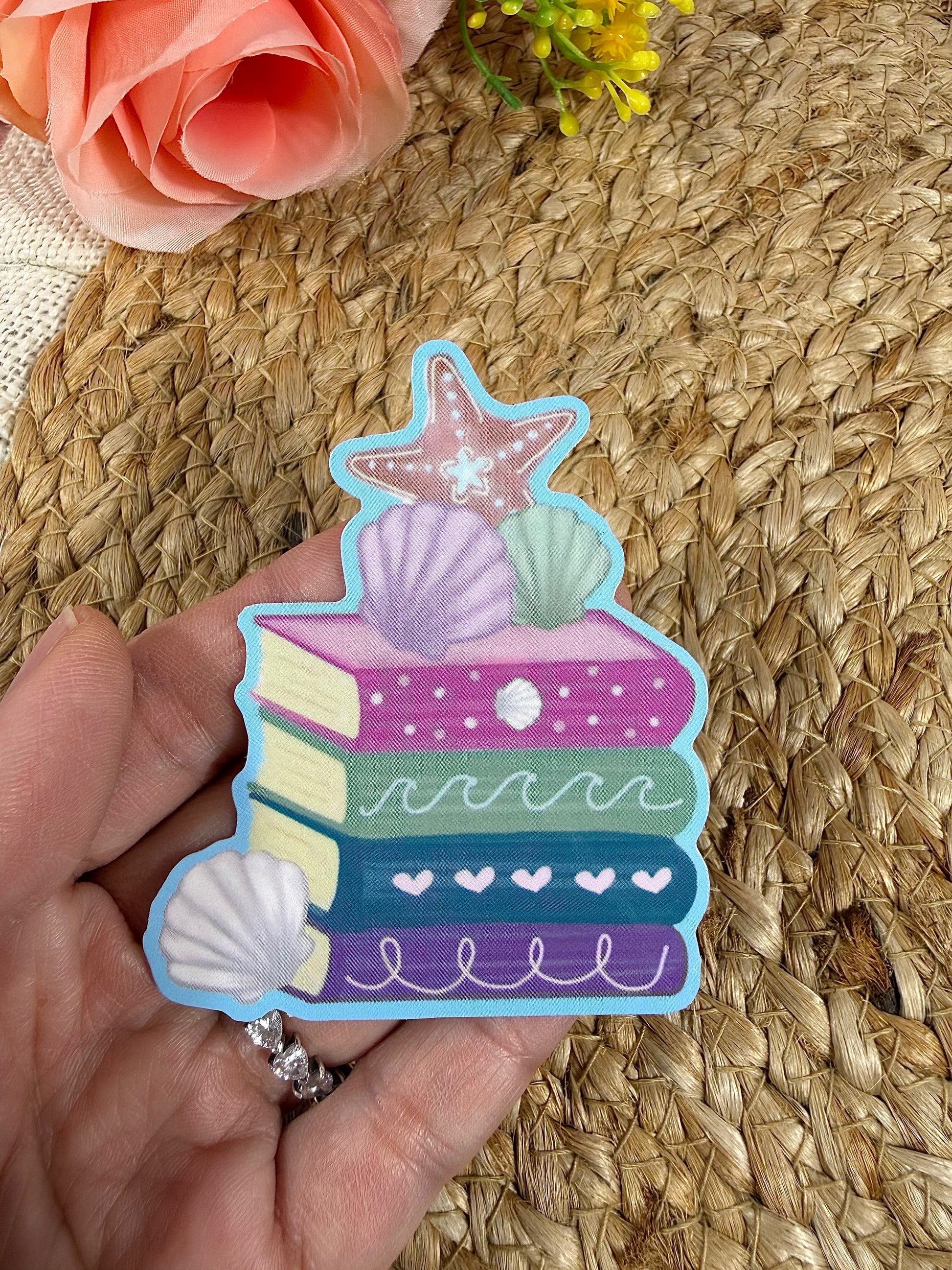 Close-up of the Beach Books Vinyl Sticker in Vinyl Glossy finish held in hand.