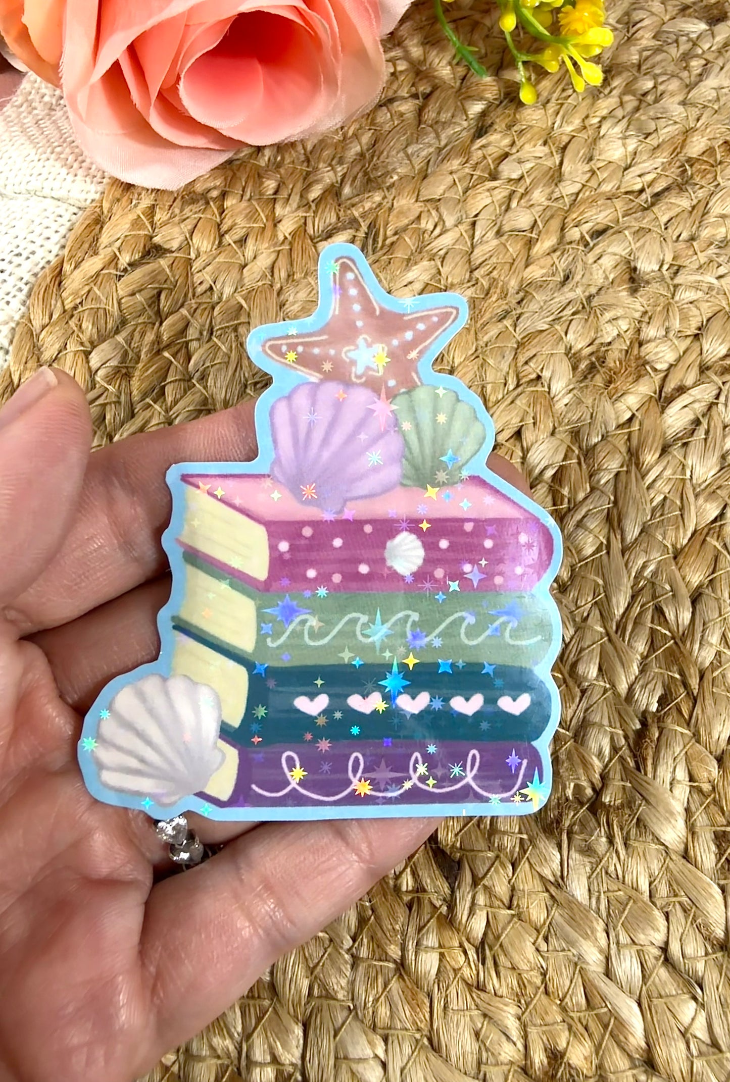 Close-up of the Beach Books Vinyl Sticker in Vinyl Star Holographic finish held in hand.