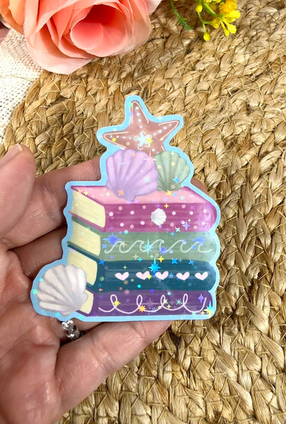 Close-up of the Beach Books Vinyl Sticker in Vinyl Star Holographic finish held in hand.