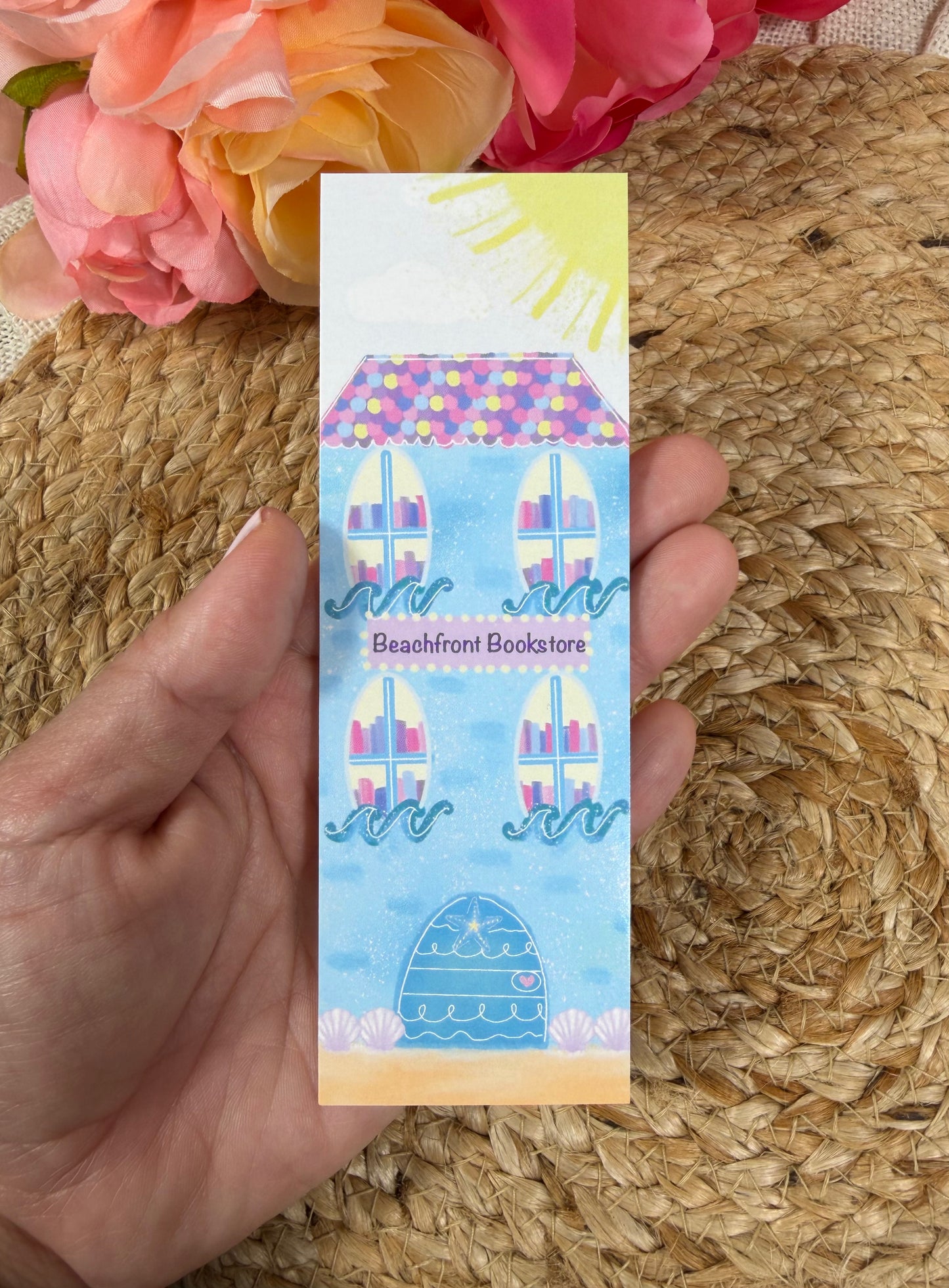 Beach Bookstore Bookmark held in hand.