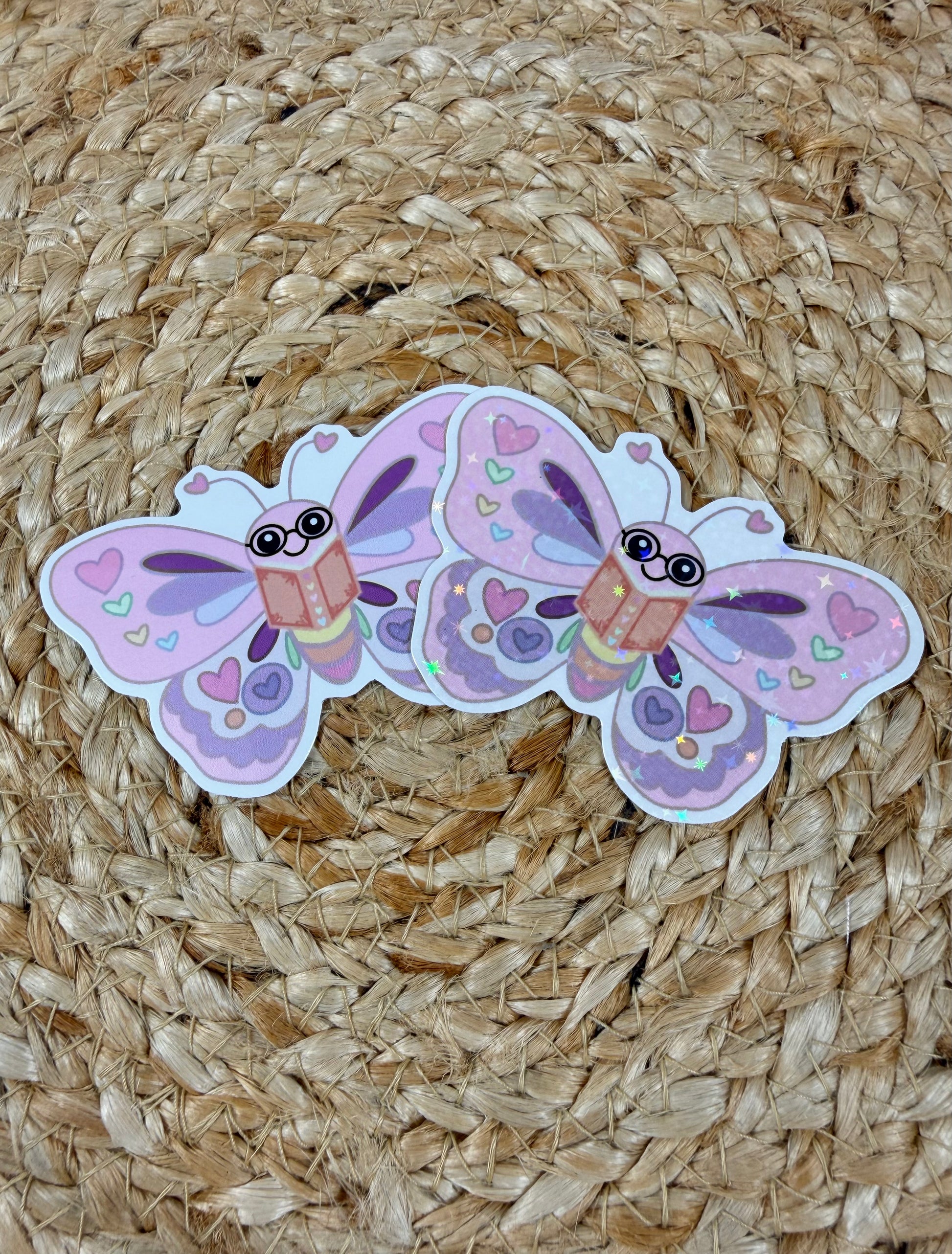 Butterfly Book Lover Vinyl Sticker shown in Vinyl Glossy and Vinyl Star Holographic finishes.