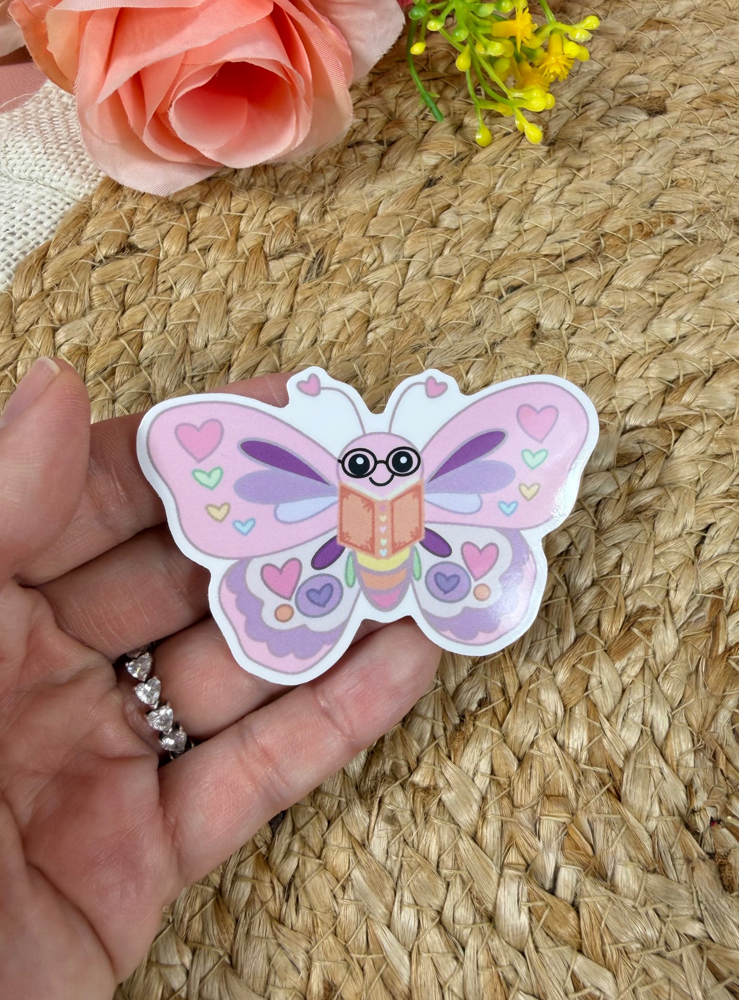 Close-up of the Butterfly Book Lover Vinyl Sticker in Vinyl Glossy finish held in hand.