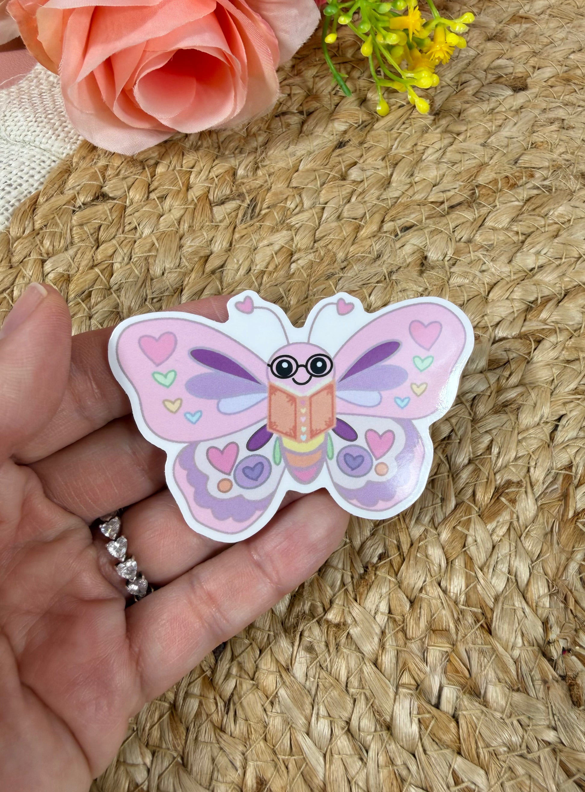 Close-up of the Butterfly Book Lover Vinyl Sticker in Vinyl Glossy finish held in hand.