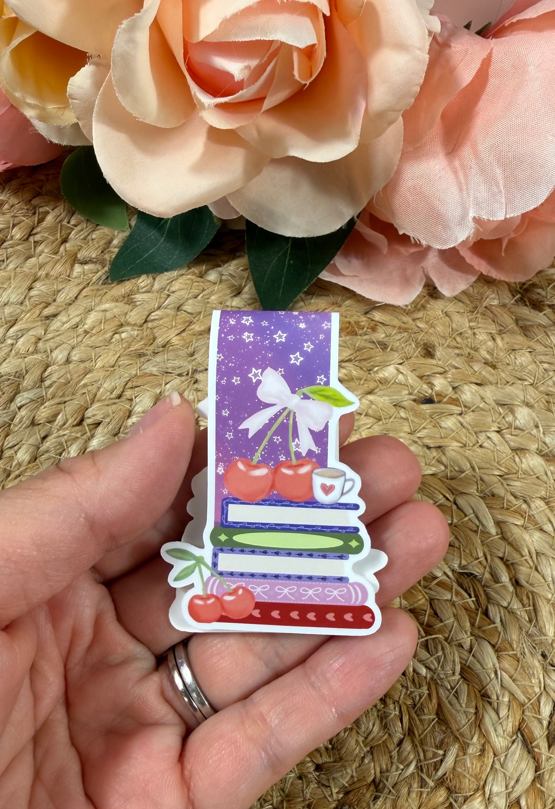 Cherry Books Magnetic Bookmark held in hand.