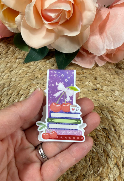 Cherry Books Magnetic Bookmark held in hand.