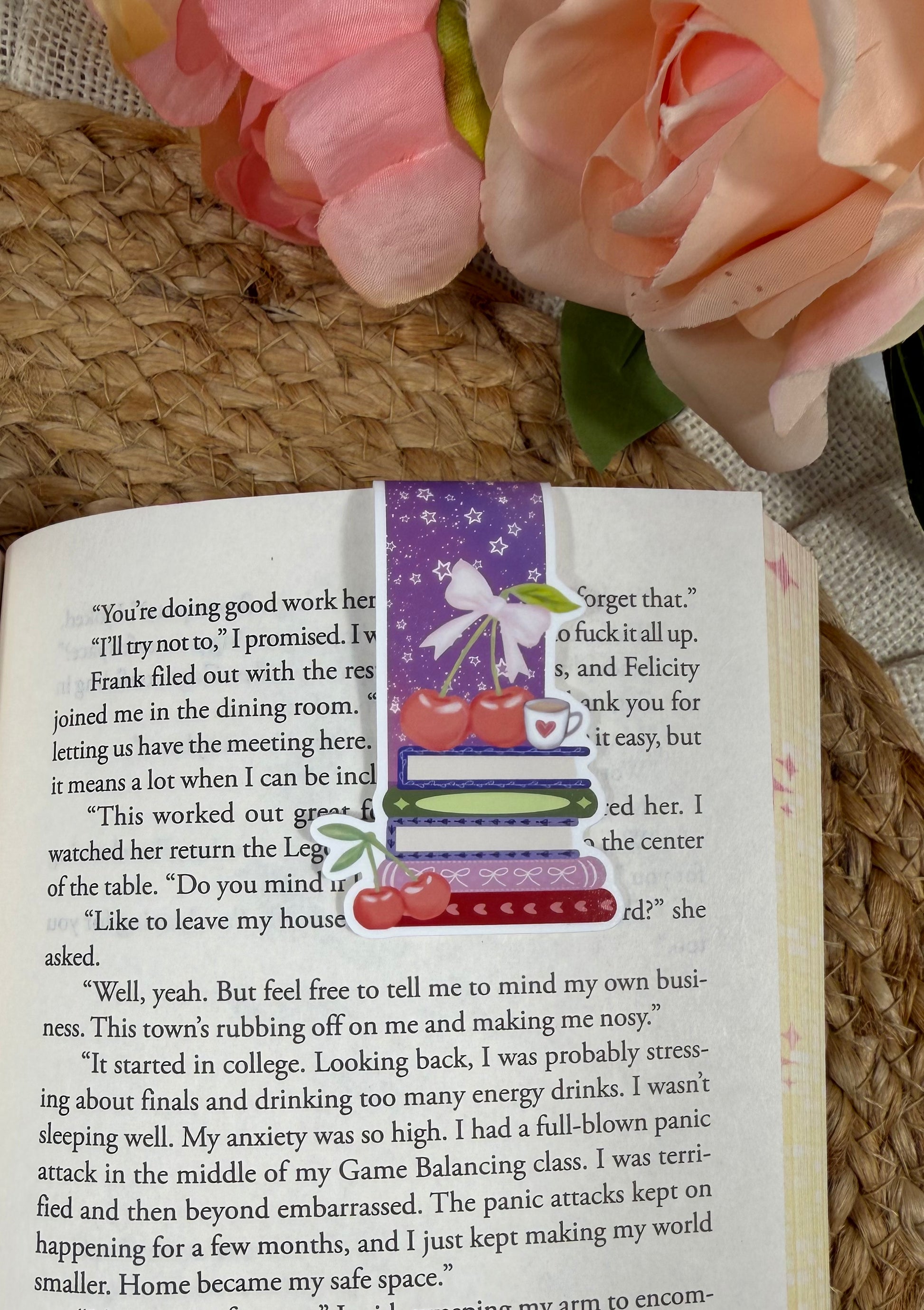Cherry Books Magnetic Bookmark clipped to a page inside a book.