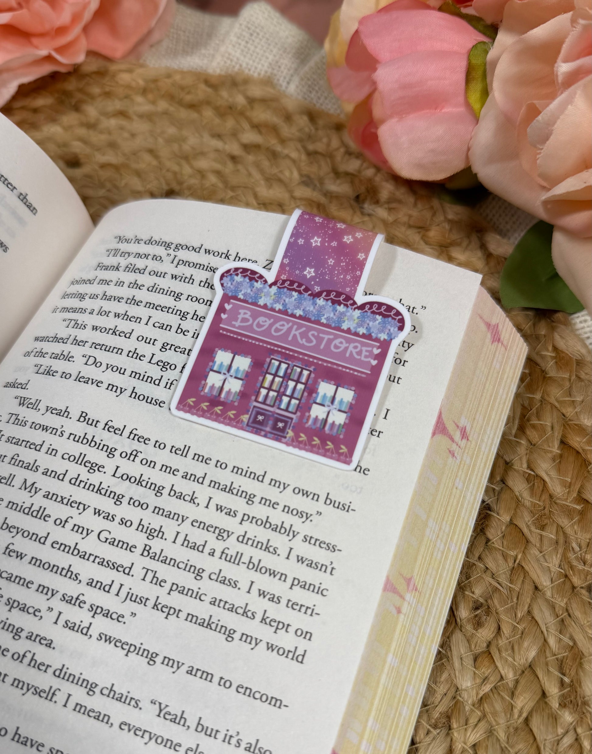 Close-up of the Cherry Bookstore Magnetic Bookmark clipped to a book page.