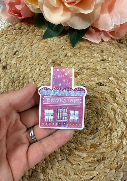 Cherry Bookstore Magnetic Bookmark held in hand.