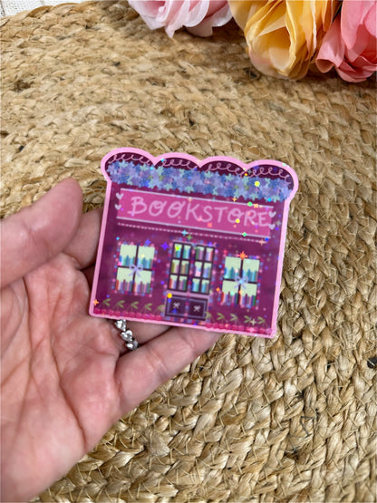 Close-up of the Cherry Bookstore Vinyl Sticker in Vinyl Star Holographic finish held in hand.