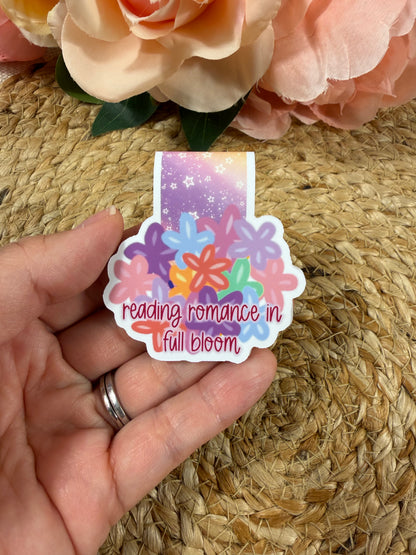 Flower Cup magnetic bookmark held in hand to show its size and colorful floral cup design.