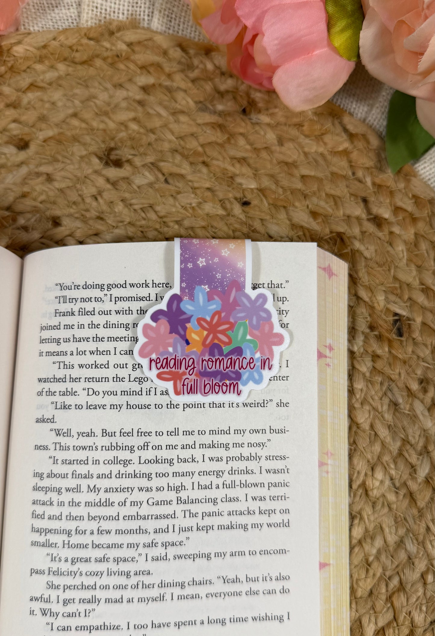 Flower Cup magnetic bookmark clipped to a book page, showing how it marks your place while reading.