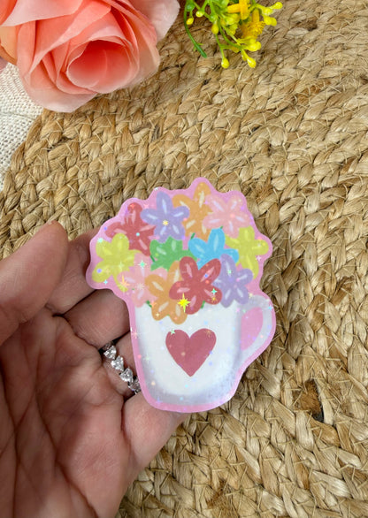 Close-up of the Flower Cup Vinyl Sticker in Vinyl Star Holographic finish held in hand.