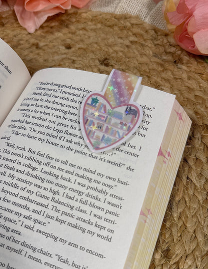 Close-up of the Kitty's Library magnetic bookmark clipped to a book page, highlighting the artwork and design details.