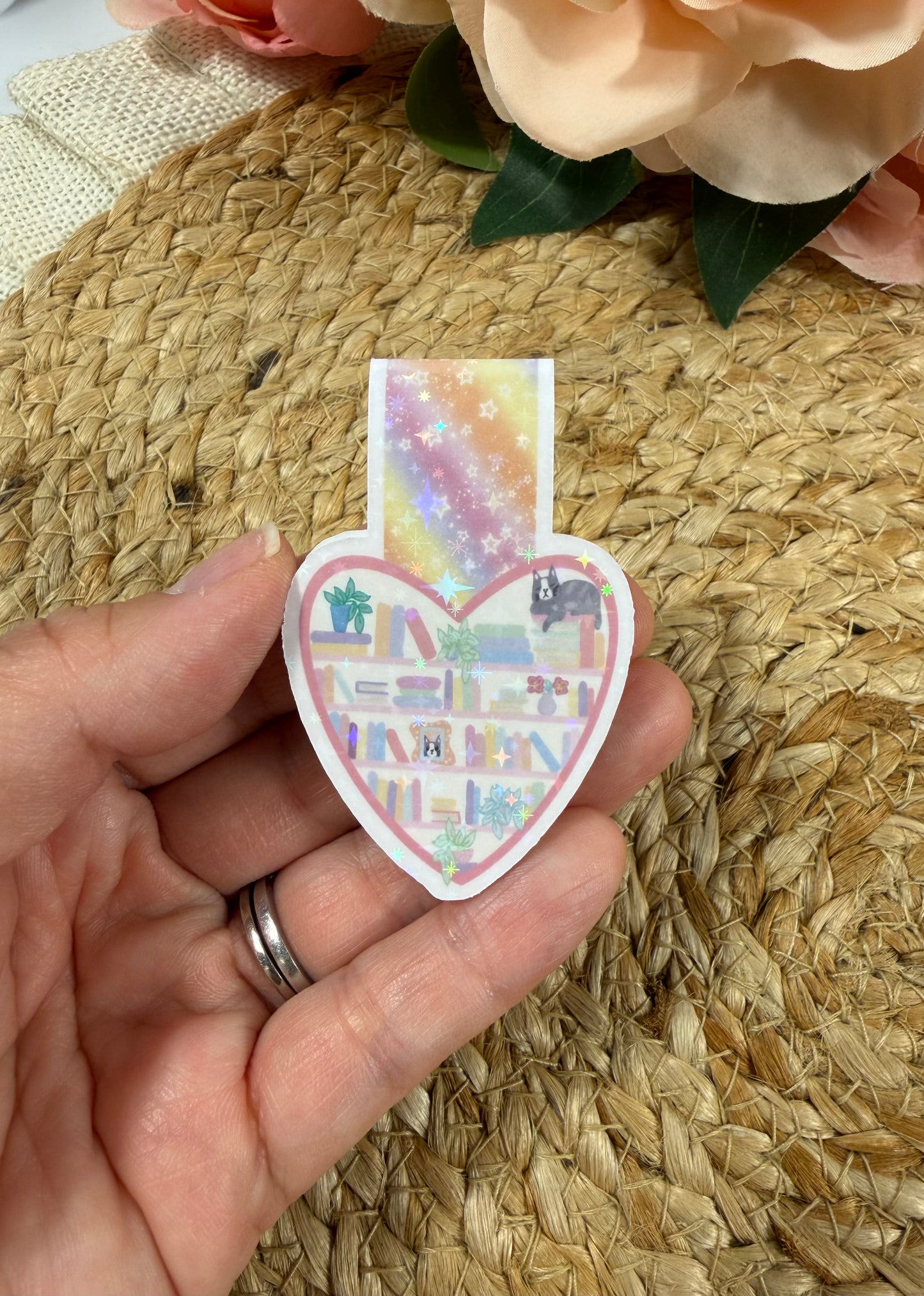 Kitty's Library magnetic bookmark held in hand to show its size and adorable kitty library design.