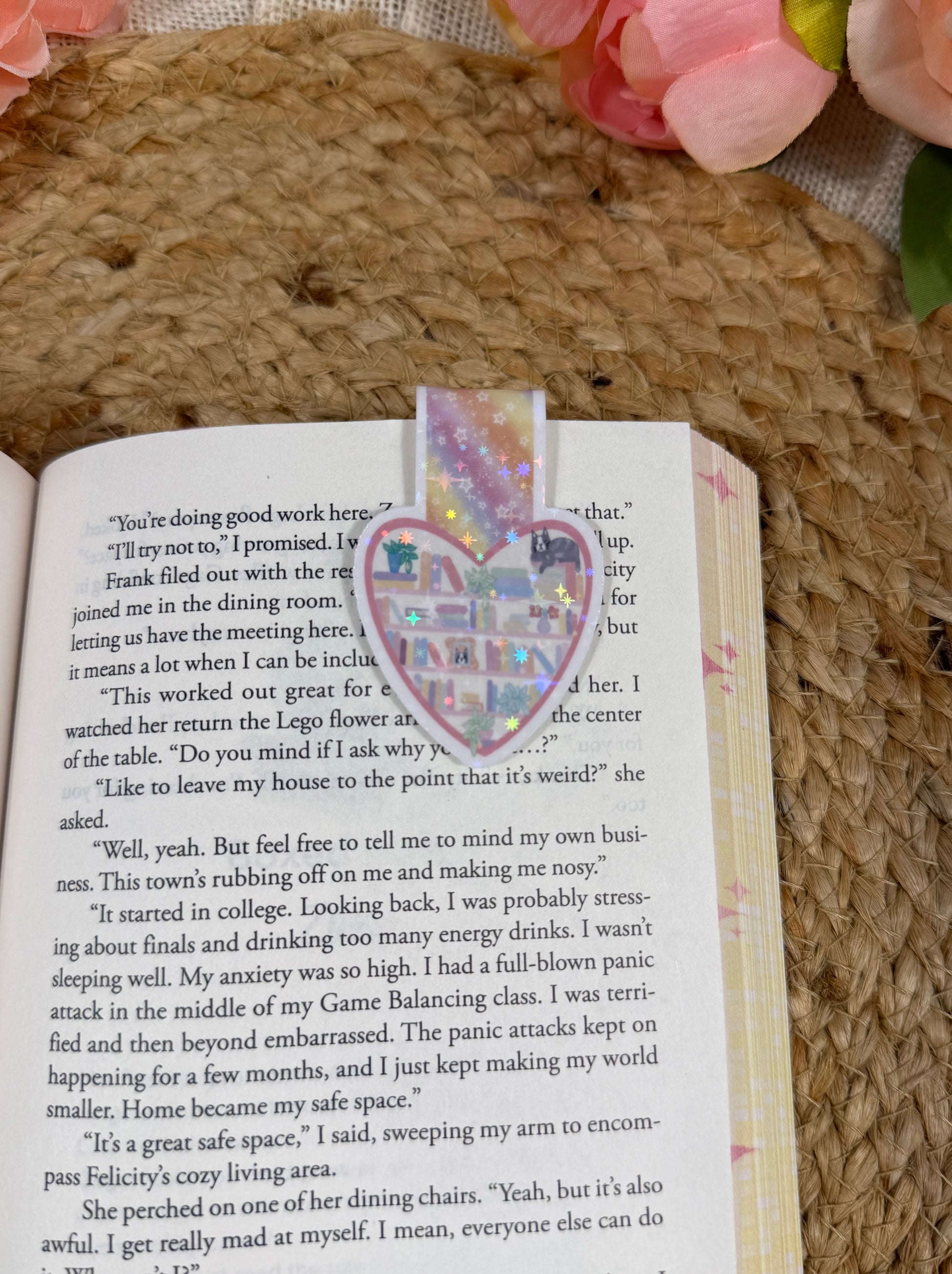 Kitty's Library magnetic bookmark clipped to a book page, showing how it marks your place while reading.