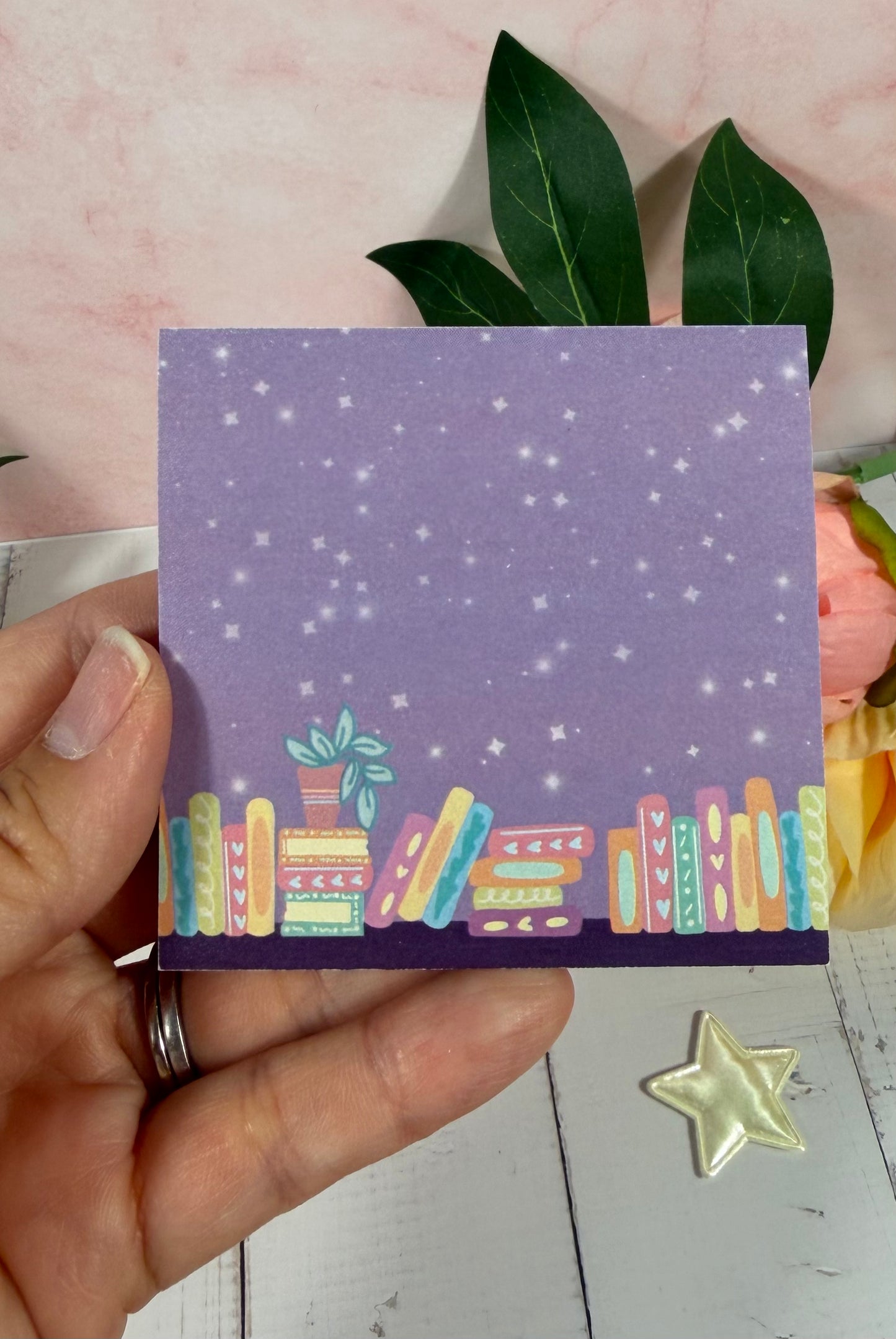 Moonlit Library Sticky Notes held in hand to show their size and design.