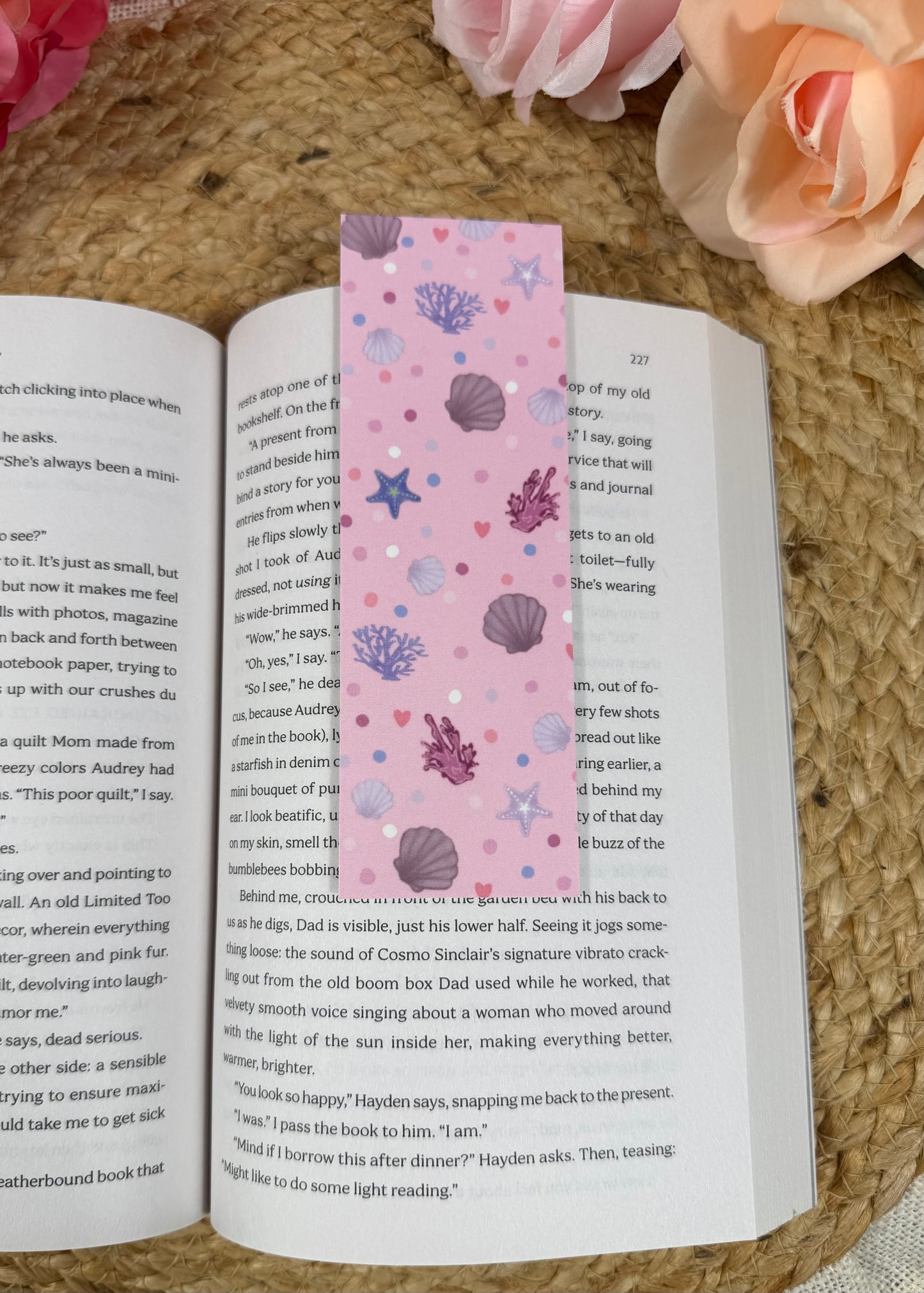 Pink Shores Bookmark marking a page inside a book.