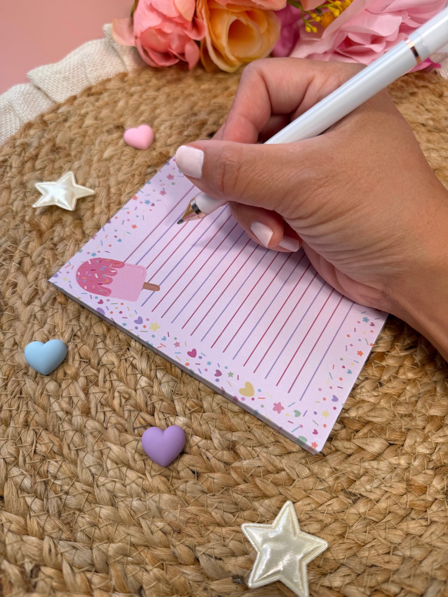 Popsicle Party Notepad held in hand with a pen to show its size and writing space.