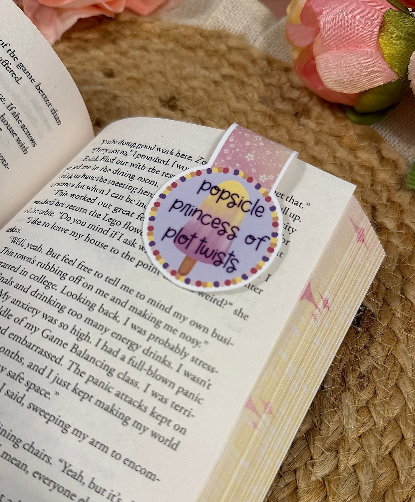 Close-up of the Popsicle Princess magnetic bookmark clipped to a book page, highlighting the artwork and design details.