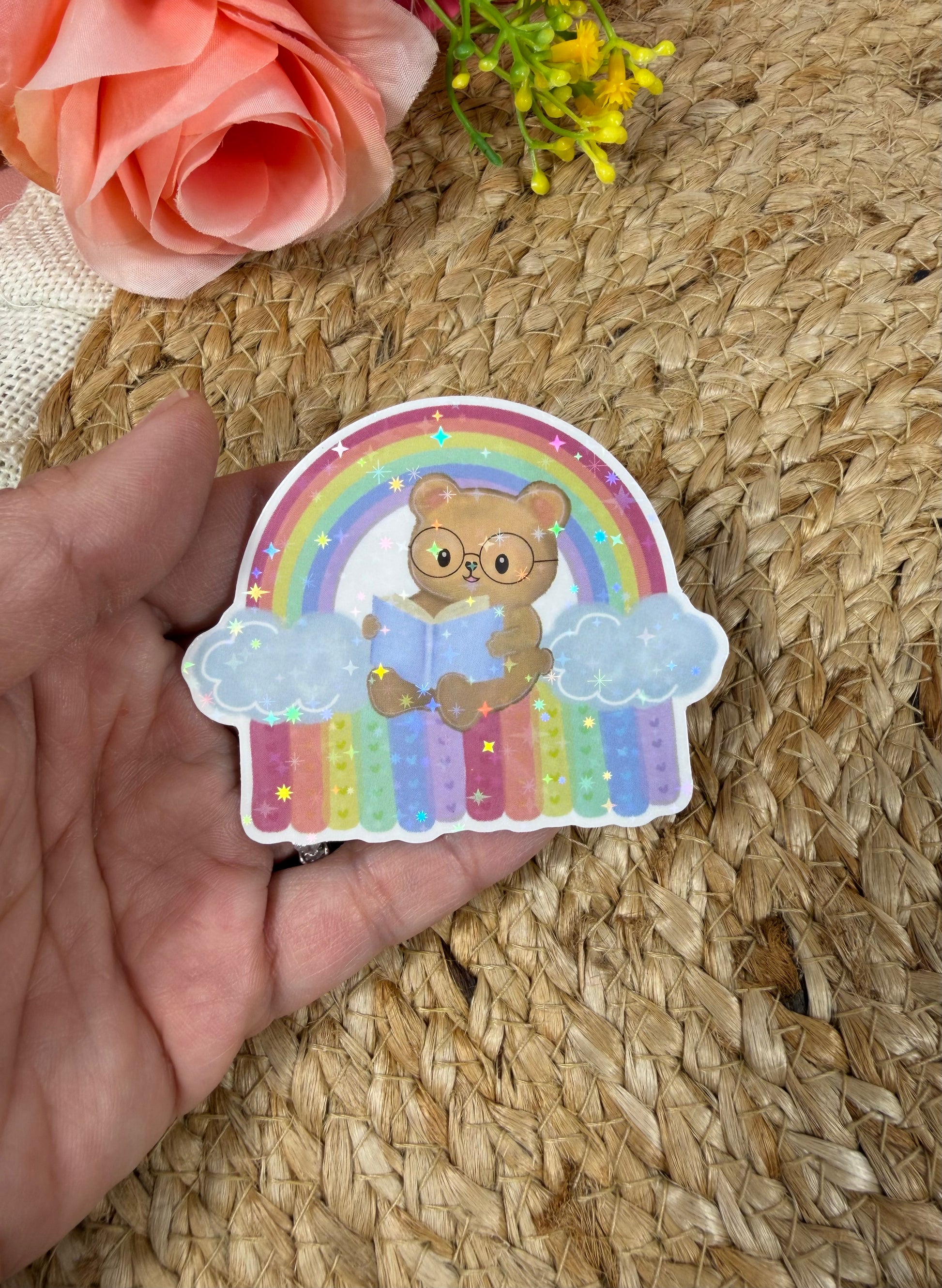 Close-up of the Rainbow Bear Vinyl Sticker in Vinyl Star Holographic finish held in hand.