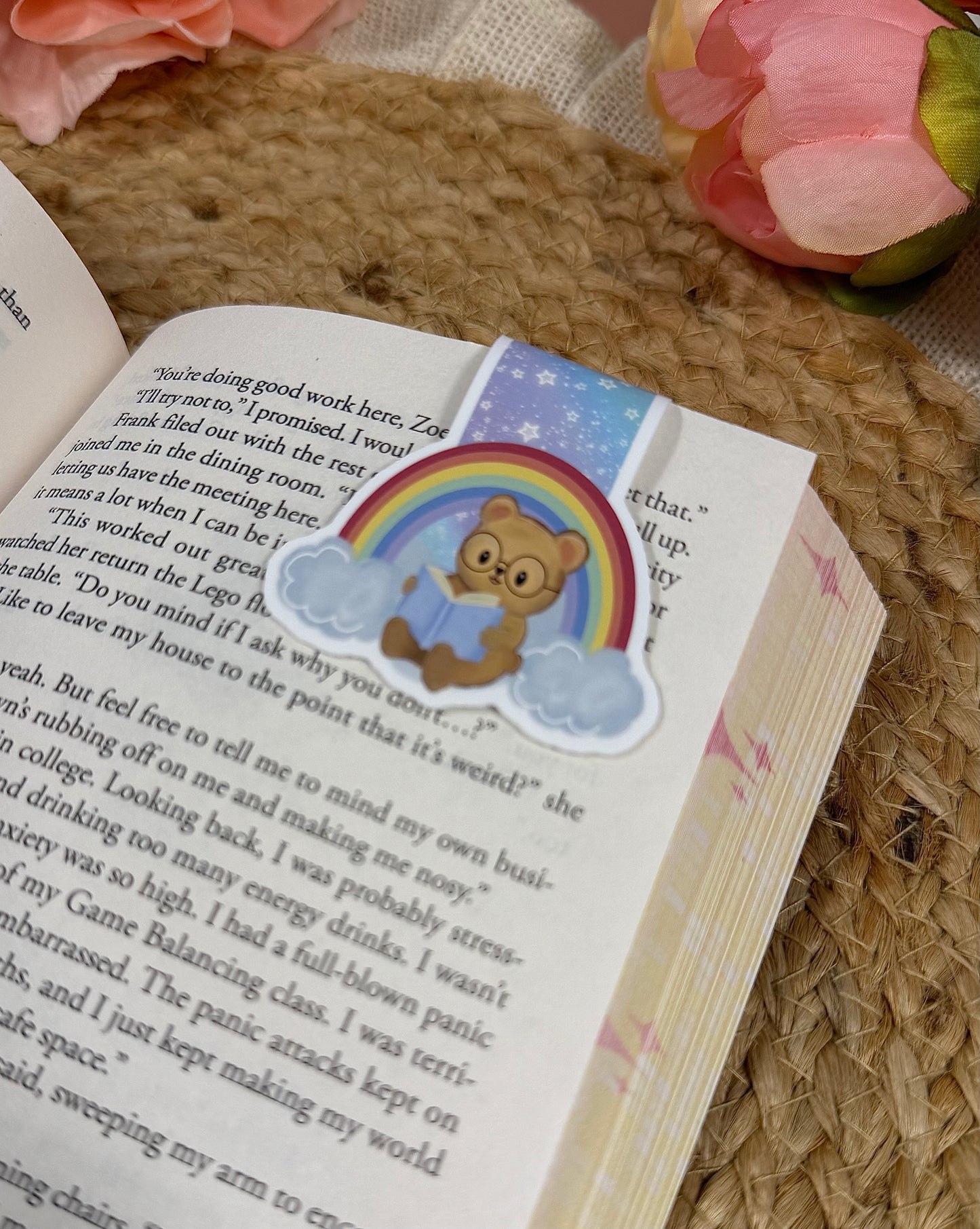 Close-up of the Rainbow magnetic bookmark clipped to a book page, highlighting the artwork and design details