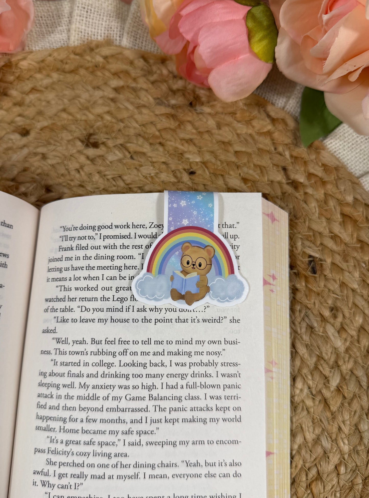 Rainbow magnetic bookmark clipped to a book page, showing how it marks your place while reading.