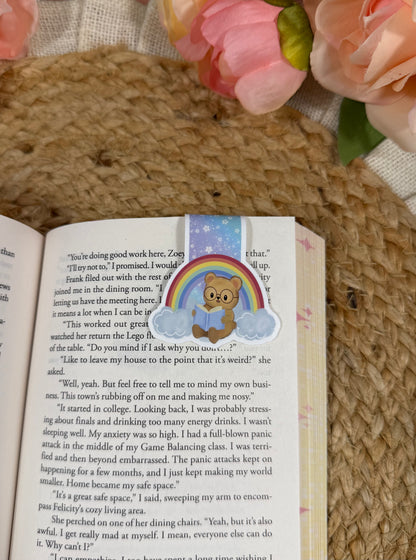 Rainbow magnetic bookmark clipped to a book page, showing how it marks your place while reading.