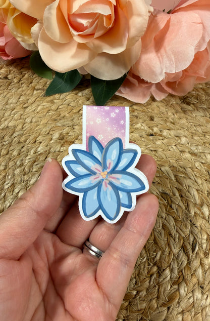 Rainbow Reading Romance magnetic bookmark held in hand to show its size and romantic rainbow floral design.