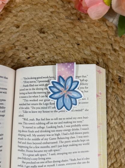 Rainbow Reading Romance magnetic bookmark clipped to a book page, showing how it marks your place while reading.