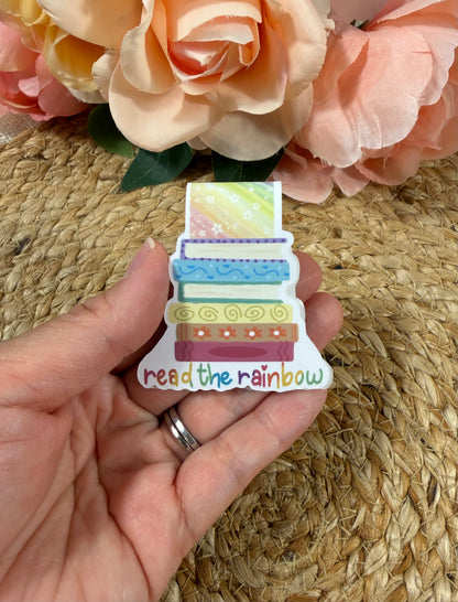 Read the Rainbow magnetic bookmark held in hand to show its size and colorful rainbow design.