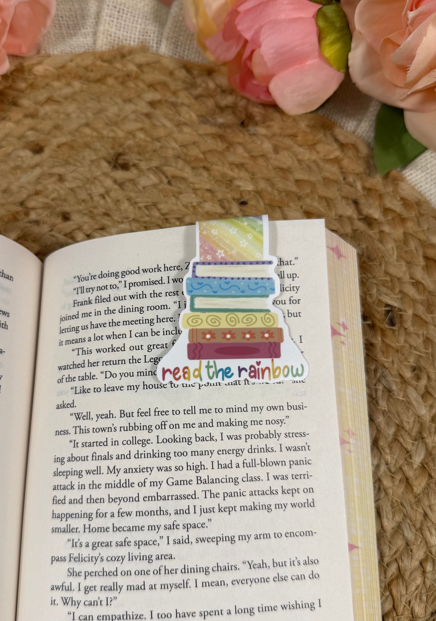 Read the Rainbow magnetic bookmark clipped to a book page, showing how it marks your place while reading.