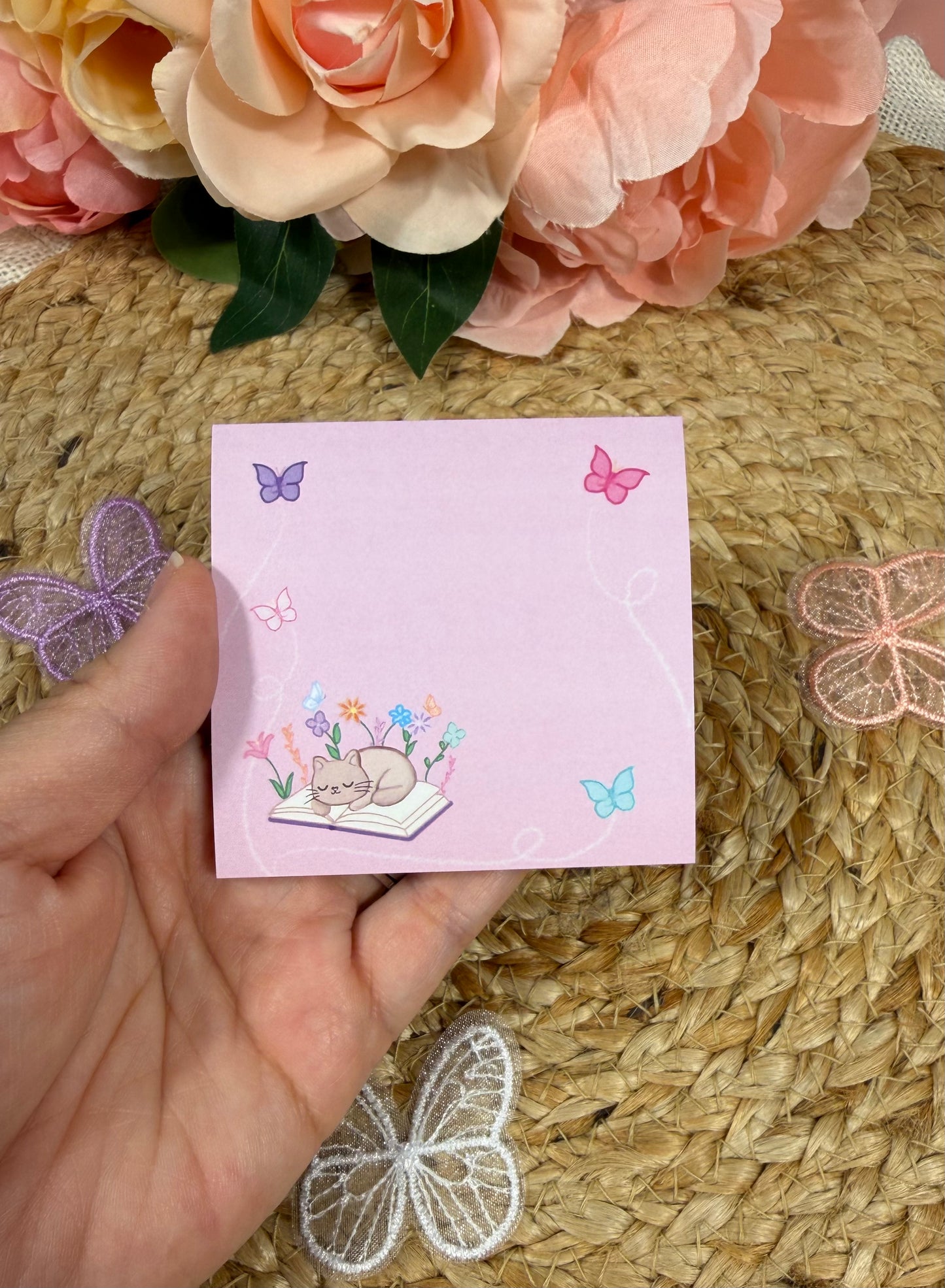 Sleepy Kitty Sticky Notes held in hand to show their size and design.