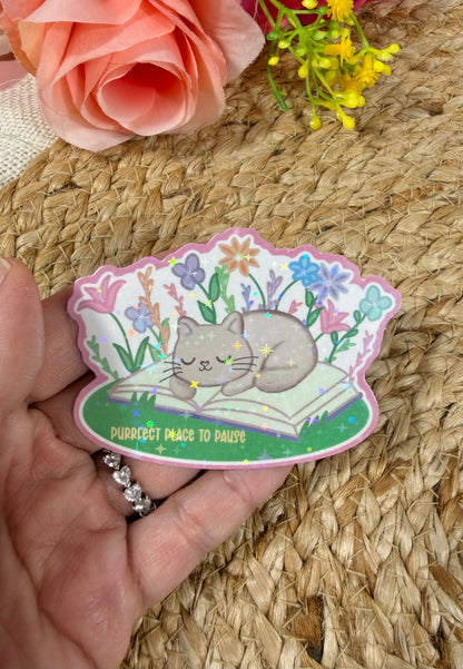 Close-up of the Sleepy Kitty Vinyl Sticker in Vinyl Star Holographic finish held in hand.