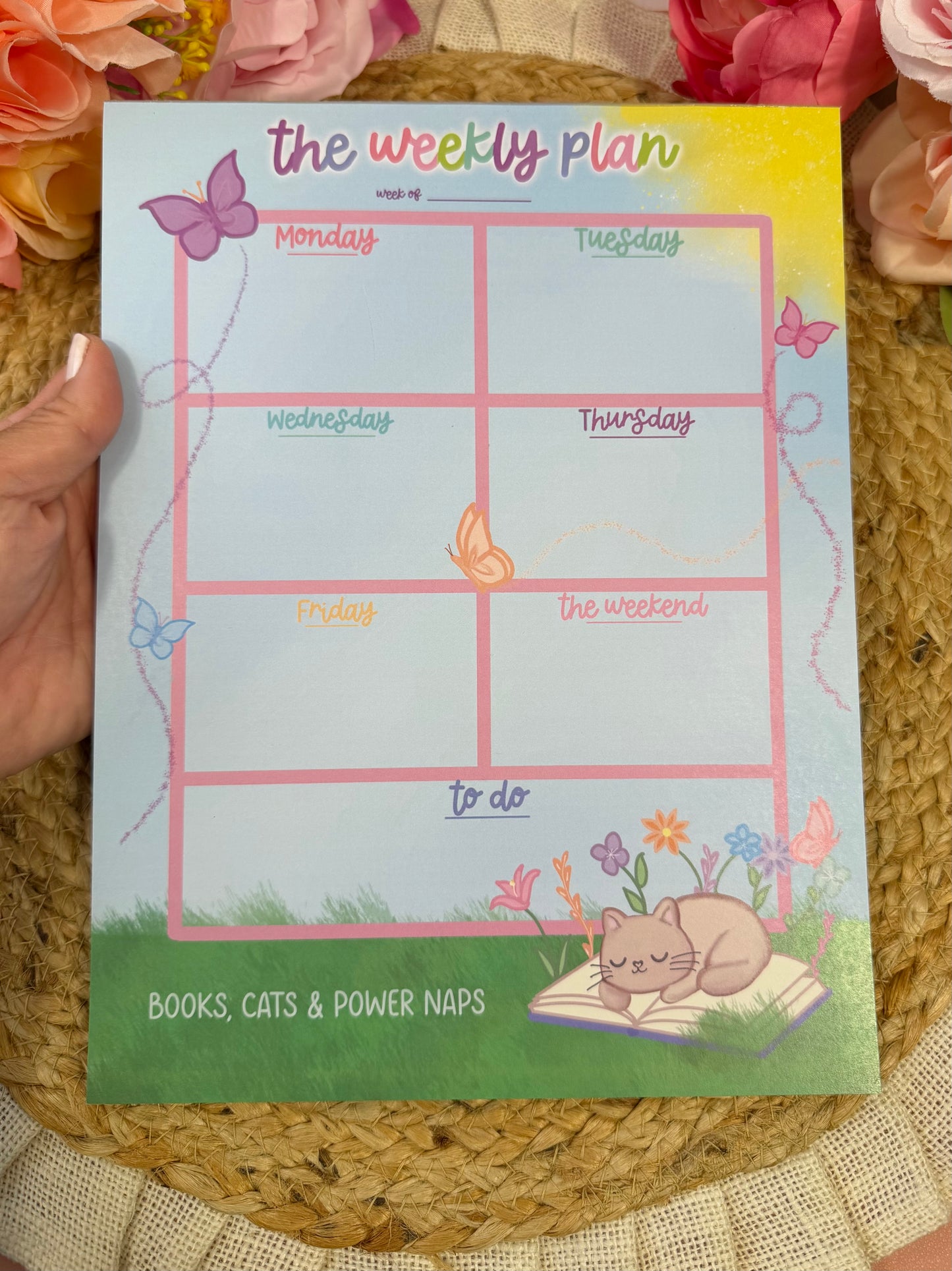 Sleepy Kitty Weekly Planner held in hand to show its size and design.