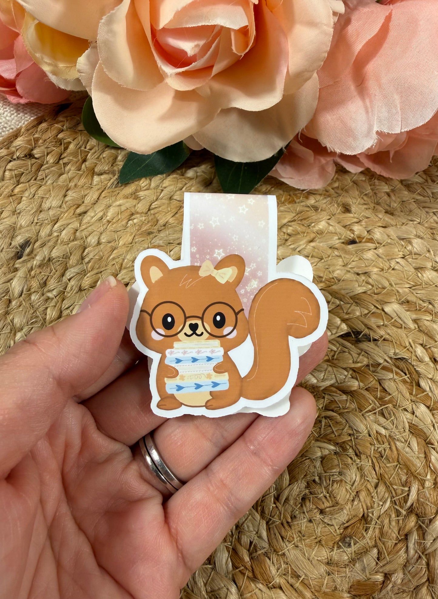 Storybook Squirrel magnetic bookmark held in hand to show its size and adorable squirrel design.