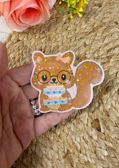 Close-up of the Storybook Squirrel Vinyl Sticker in Vinyl Star Holographic finish held in hand.