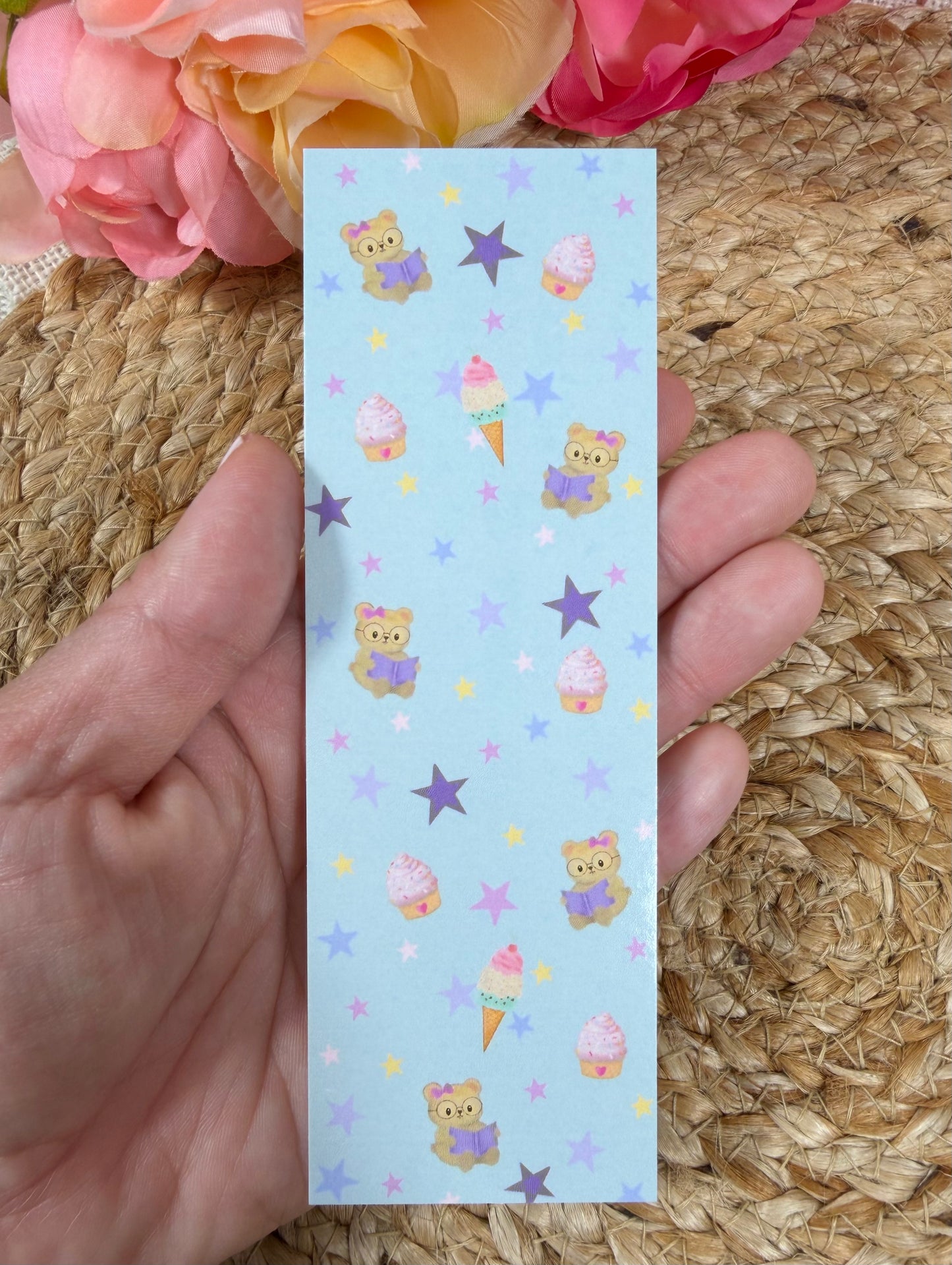 Sweet Tooth Teddy Bookmark held in hand.