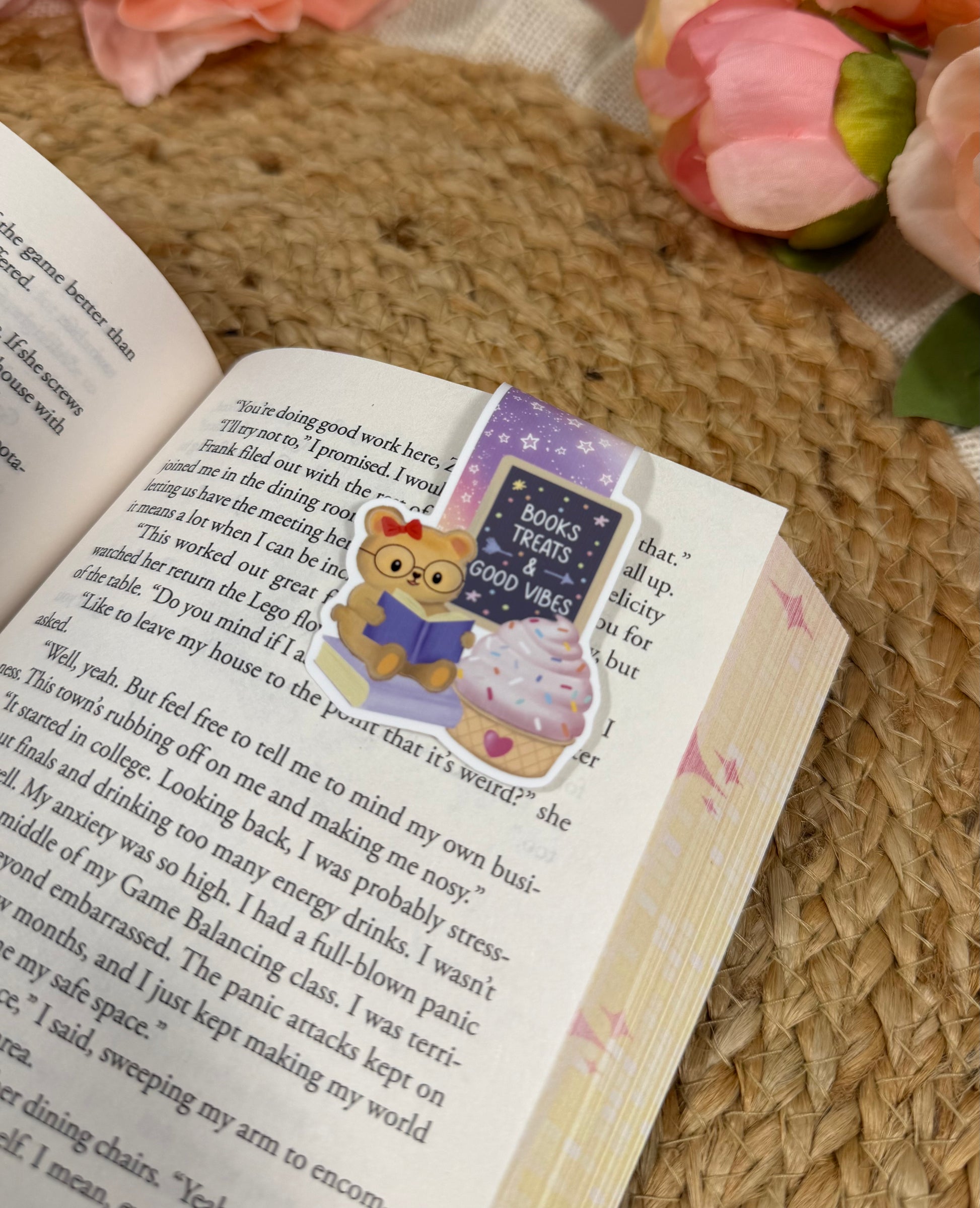 Close-up of the Sweet Tooth Teddy Magnetic Bookmark clipped to a book page.