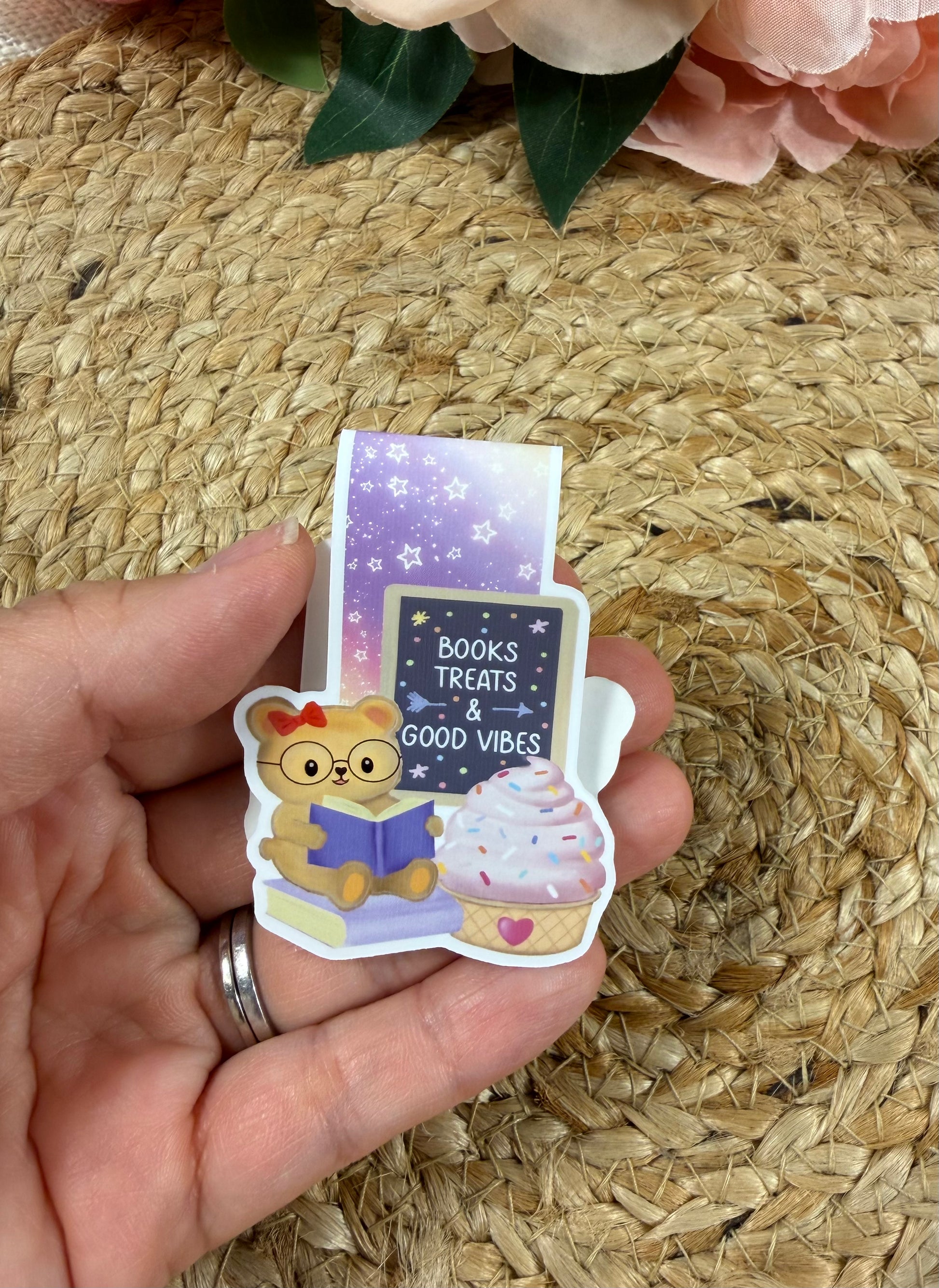 Sweet Tooth Teddy magnetic bookmark held in hand to show its size and adorable teddy bear design.
