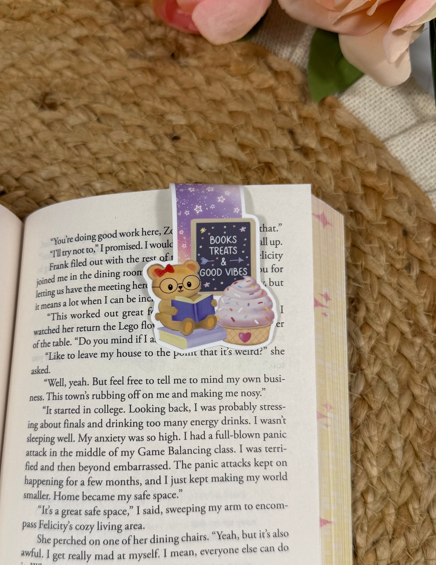 Sweet Tooth Teddy Magnetic Bookmark clipped to a page inside a book.