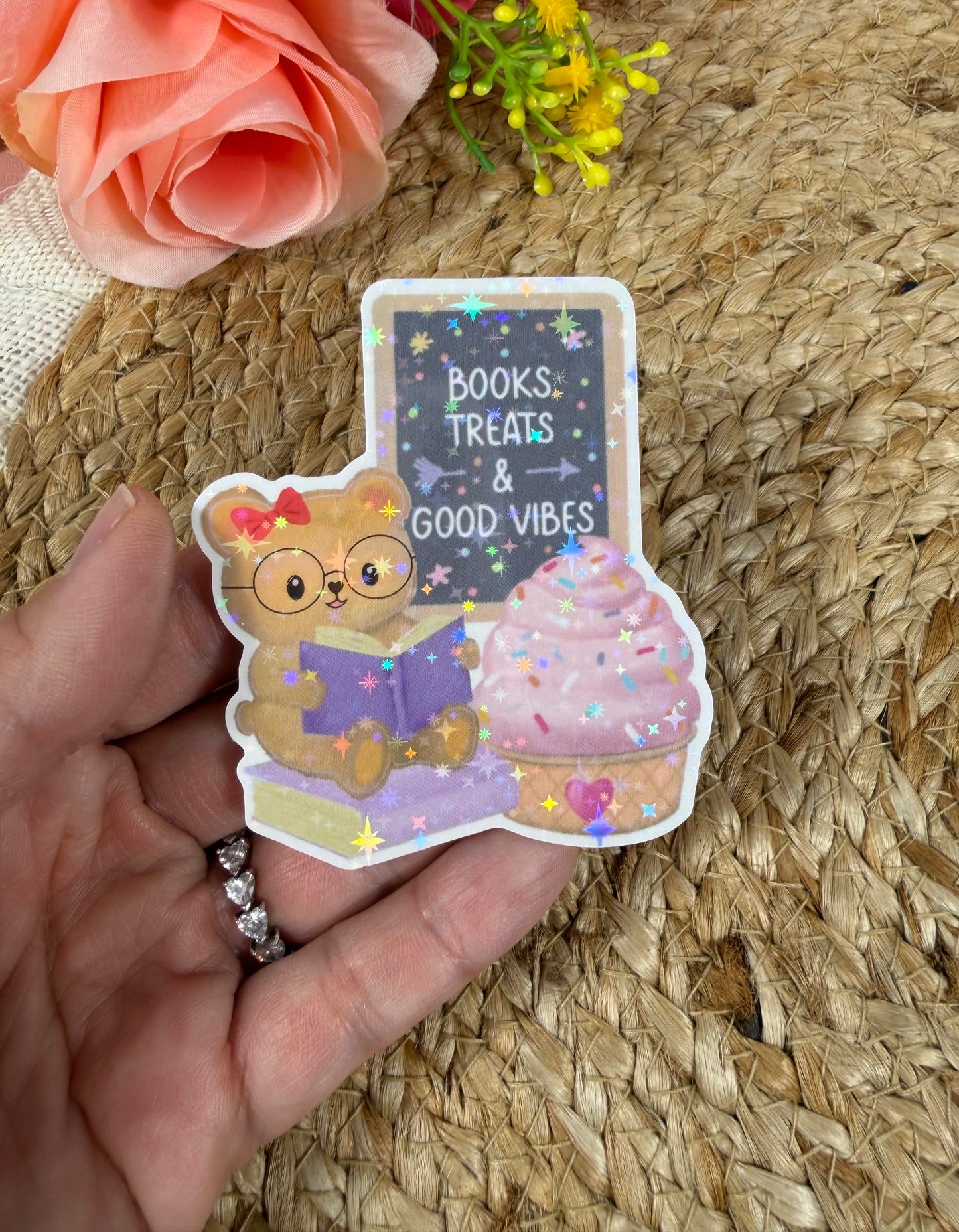 Close-up of the Sweet Tooth Teddy Vinyl Sticker in Vinyl Star Holographic finish held in hand.
