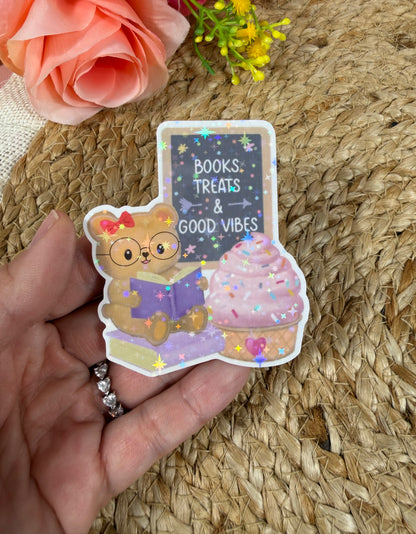 Close-up of the Sweet Tooth Teddy Vinyl Sticker in Vinyl Star Holographic finish held in hand.
